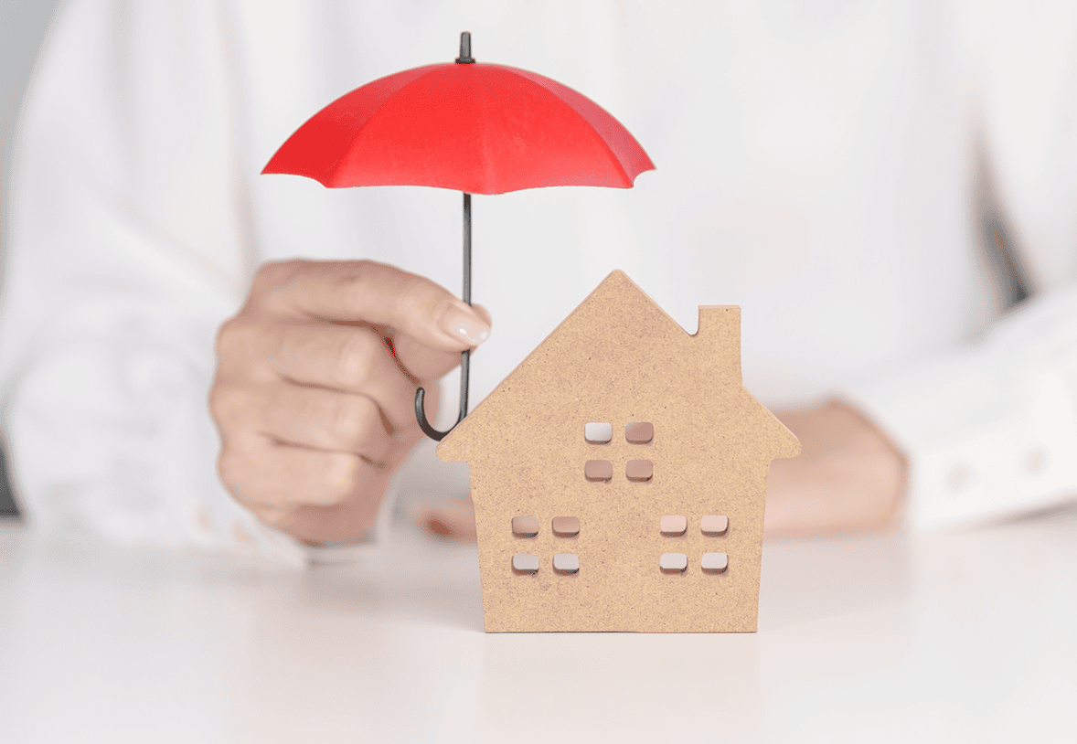 Small wooden house under red umbrella