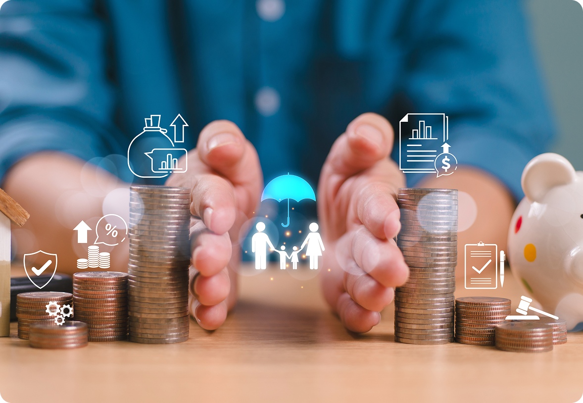 Hands protecting stacked coins on table