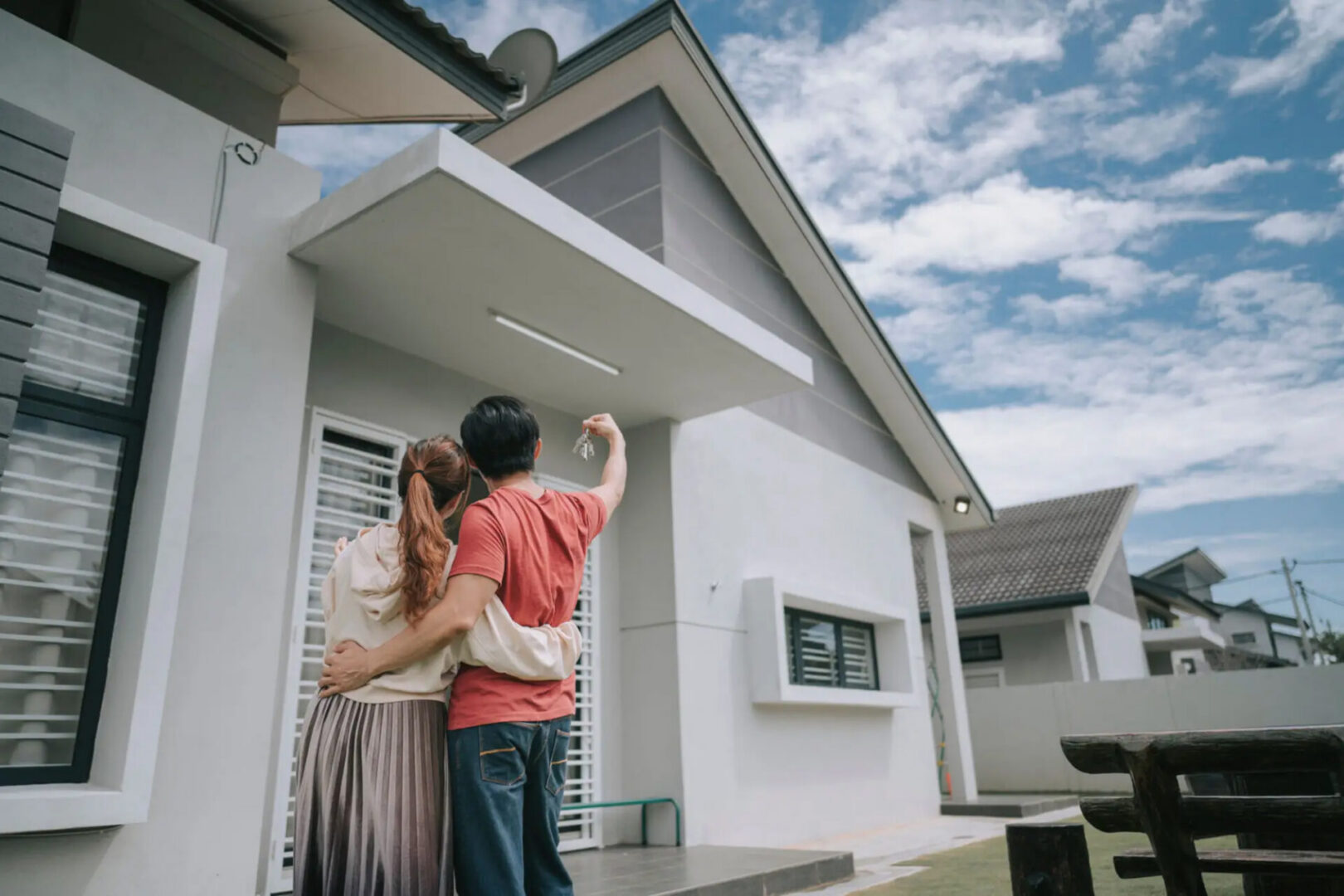 Couple admiring new modern house together