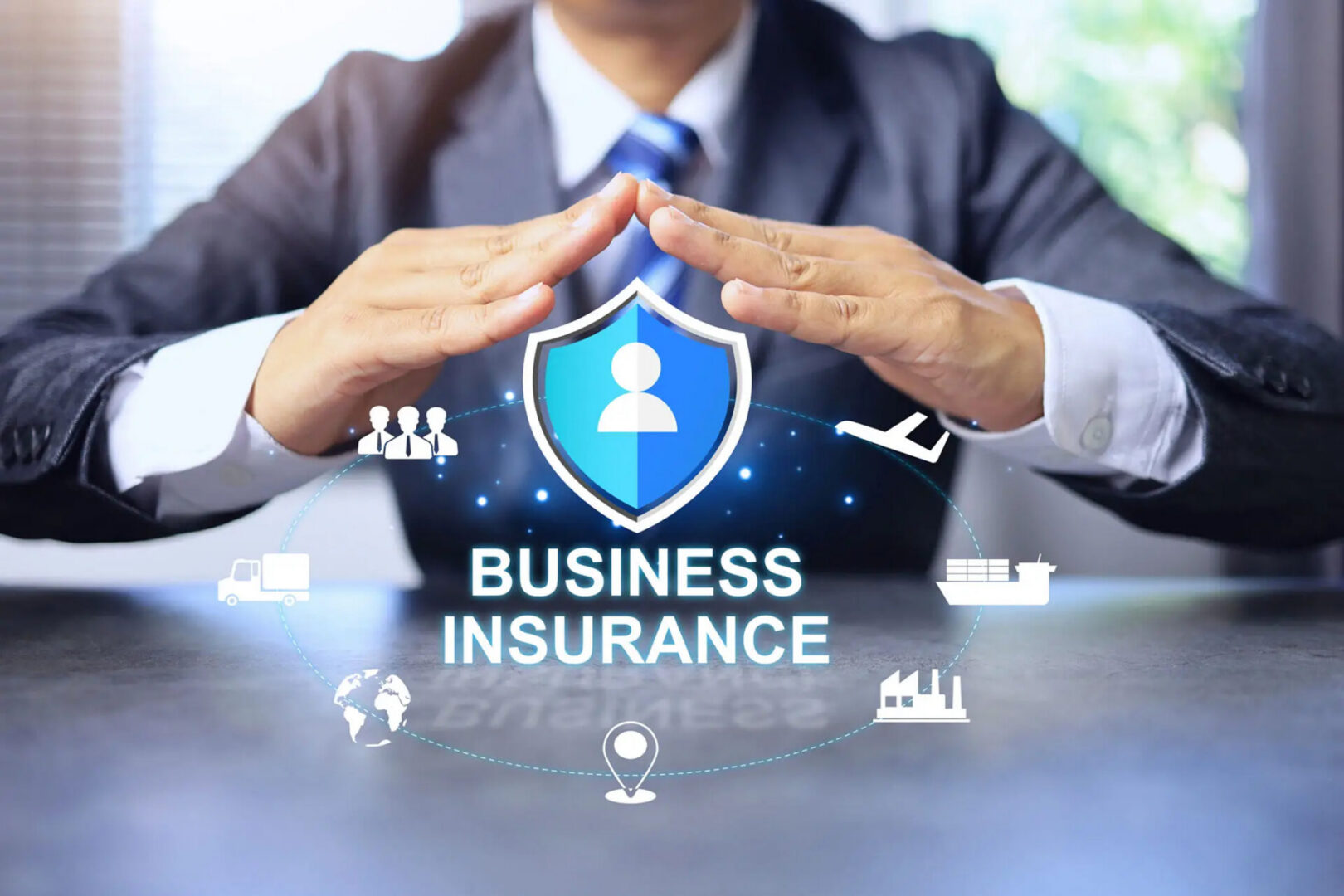 Hands protecting business insurance shield