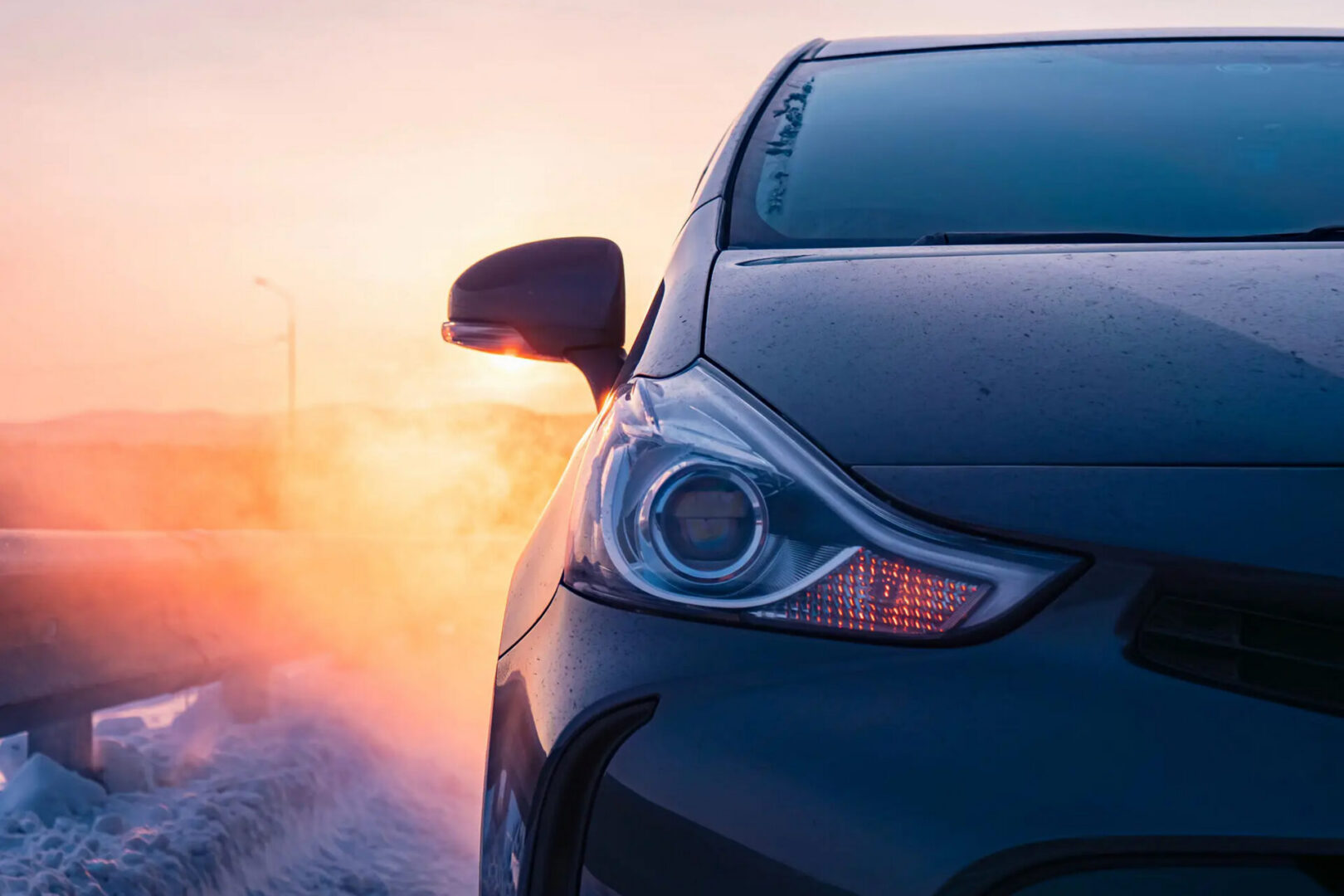 Close-up of car headlight at sunrise