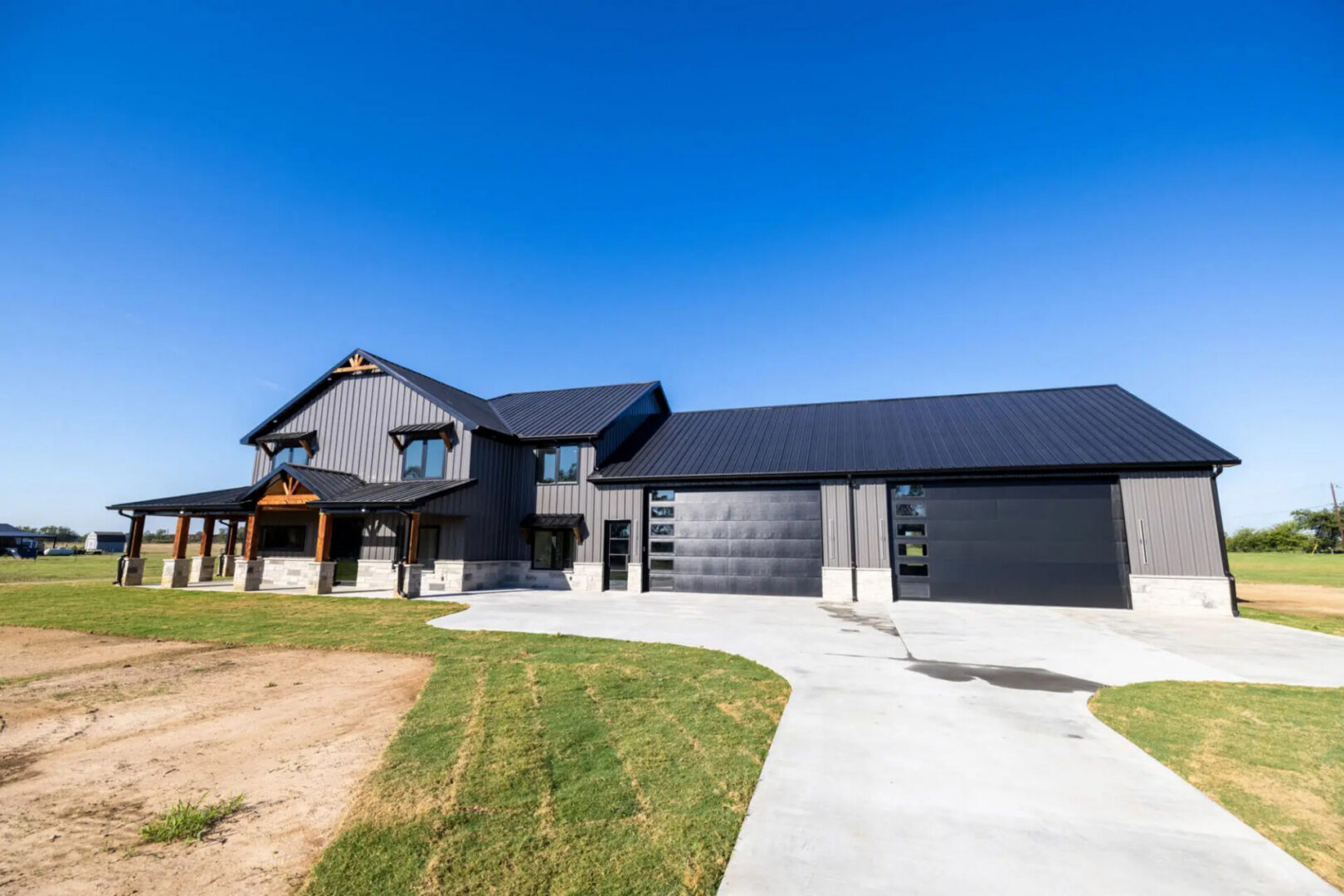 Modern black metal farmhouse with three-car garage