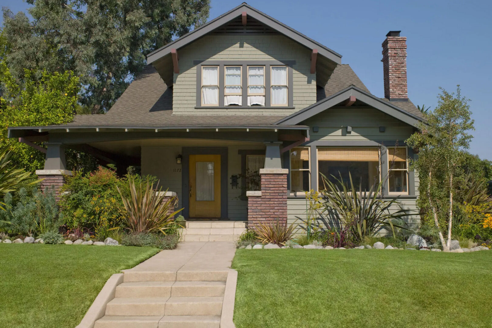 Craftsman-style house with front porch and lawn